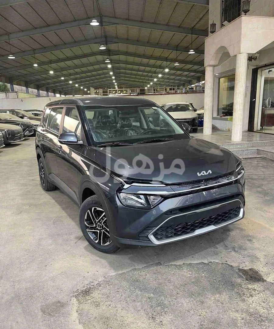 The car is a Kia Carens, standard category, upgraded with a screen and camera